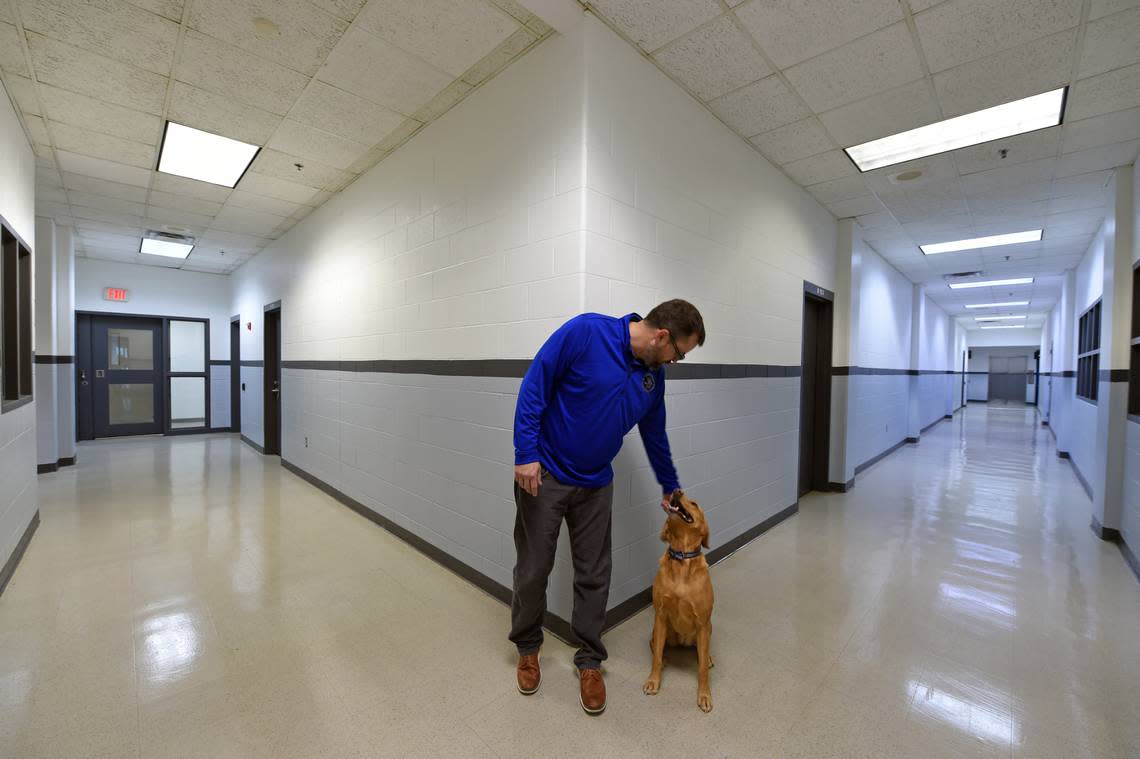 While stopping at the Douglas County Jail, Sheriff Jay Armbrister pets his dog “Lucy”, who is his constant companion. Photo by Dave Kaup