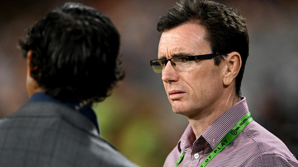 Ben Ikin is pictured on the sidelines of an NRL match.