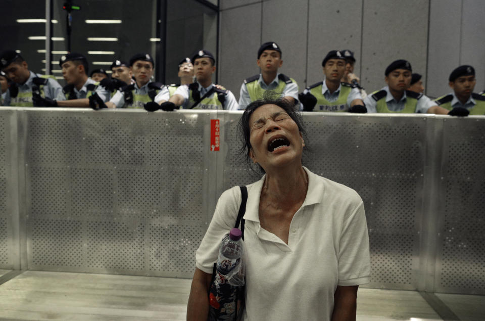 FILE - In this June 10, 2019, file photo, a protester reacts near a police line during a rally against the proposed amendments to the extradition law at the Legislative Council in Hong Kong. China’s central government has dismissed Hong Kong pro-democracy protesters as clowns and criminals while bemoaning growing violence surrounding the monthslong demonstrations.(AP Photo/Vincent Yu, File)