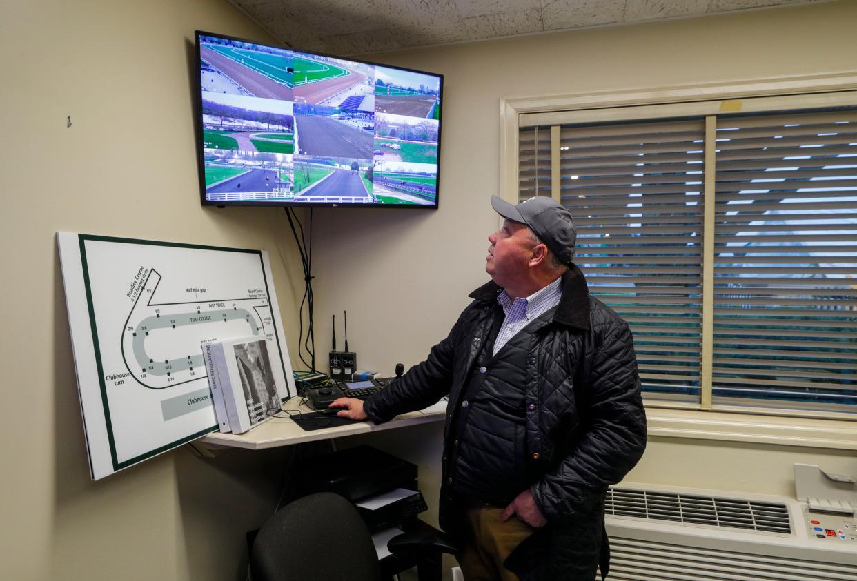 Dr. Stuart Brown looks at a video monitor that has access to 11 cameras of the racetrack at Keeneland. Vets are able to position the cameras remotely and zoom in while keeping watch on race horses as part of their daily practice. April 7, 2023