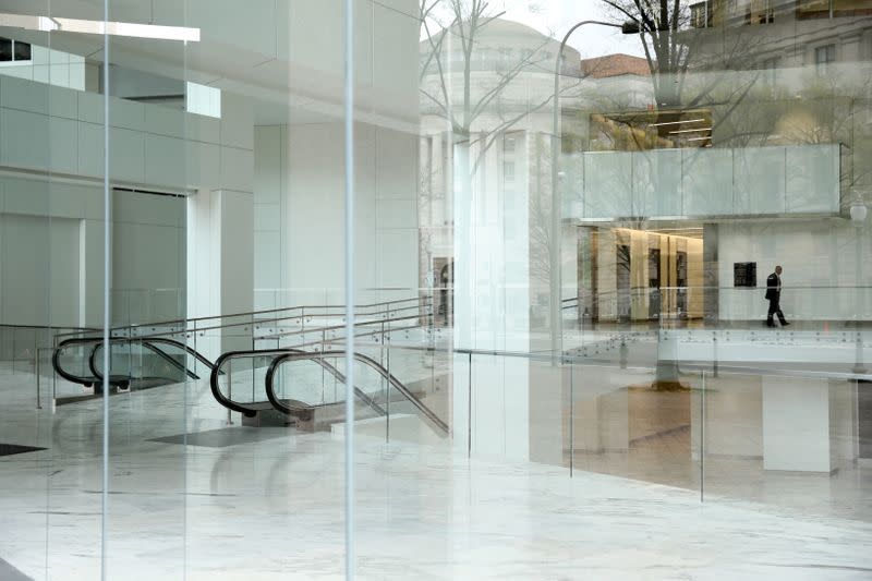 A security guard keeps watch over an empty building lobby Pennsylvania Avenue in during the coronavirus outbreak in downtown Washington