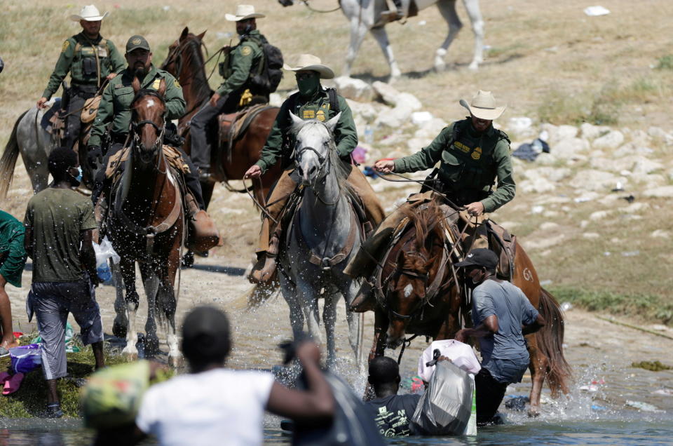 U.S. border patrol officers cut the way of migrants asylum seekers as they are trying to return to the United States along the Rio Grande river, after having crossed from the United States into Mexico to buy food, as seen from Ciudad Acuna, in Ciudad Acuna, Mexico September 19, 2021. REUTERS/Daniel Becerril