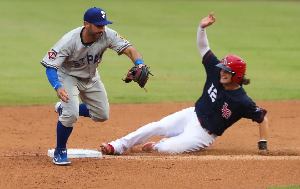 The Louisville Bats Brantley Bell (12) was safe at second as St. Paul Saints Daniel Descalso (13) tried to make a throw to first during their game at Slugger Field in Louisville, Ky. on June 2, 2021.