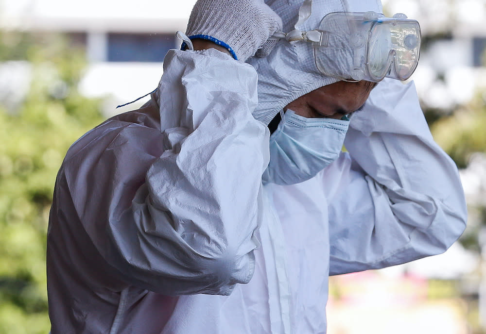 Jee Jeet Yuan, 49, suits up as he prepares to carry out decontamination work at the Special Children’s Centre in George Town, April 4, 2020. — Picture by Sayuti Zainudin