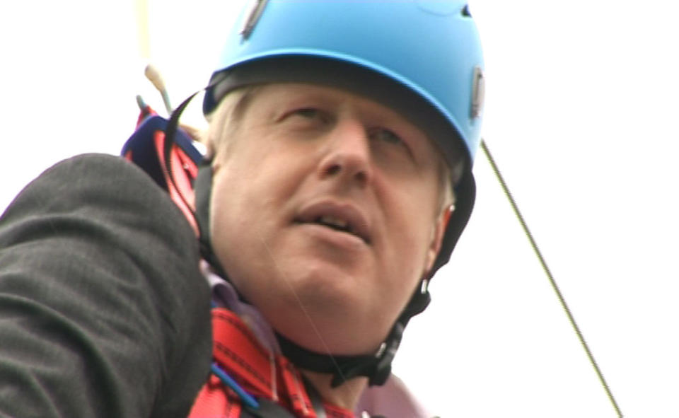 London Mayor Boris Johnson as he is left hanging in mid-air after he got stuck on a zipwire at an Olympic event at Victoria Park in the capital.   (Photo by Ben Kendall/PA Images via Getty Images)