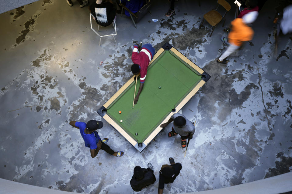 People play pool in Harare, capital of Zimbabwe, Thursday, Nov. 24, 2022. Previously a minority and elite sport in Zimbabwe, the game has increased in popularity over the years, first as a pastime and now as a survival mode for many in a country where employment is hard to come by. (AP Photo/Tsvangirayi Mukwazhi)