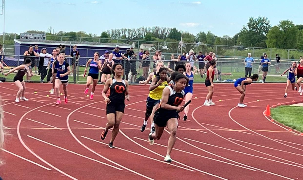 Freeport's Tania McElroy hands off to her twin sister Ta'Leiah McElroy as they begin to pull away for the win in the 4x100-meter relay win on Wednesday, May 8, 2024, in Rochelle.
