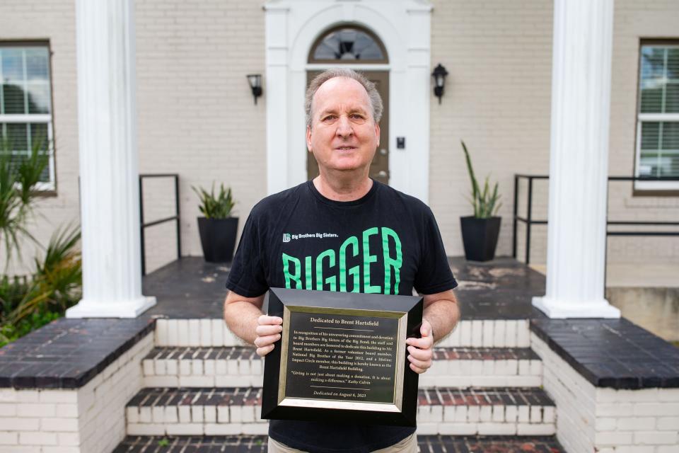 Brent Hartsfield, holds a plaque gifted to him when Big Brothers and Big Sisters of the Big Bend named the building “Brent Hartsfield Building,” after him Tuesday, Sept. 12, 2023.