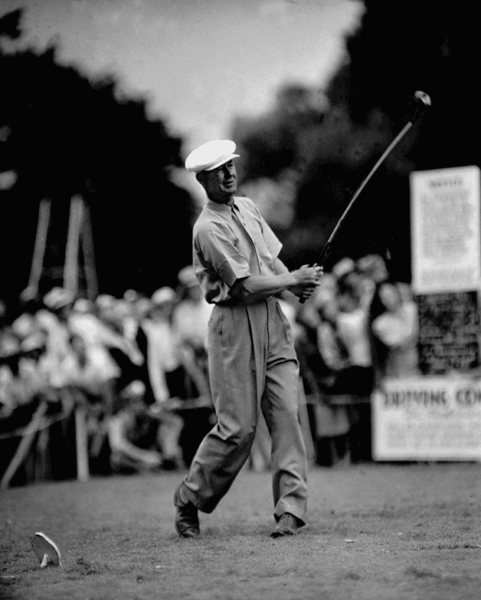 Defending champion Byron Nelson puts a curve in the shaft of his driver in this July 28, 1945 file photo while participating in the $60,000 All-American Golf Tournament at Tam O'Shanter Country Club in Chicago. Nelson, who had the greatest year in the history of professional golf when he won 18 tournaments in 1945, including a record 11 in a row, died Tuesday, Sept. 26, 2006. He was 94.