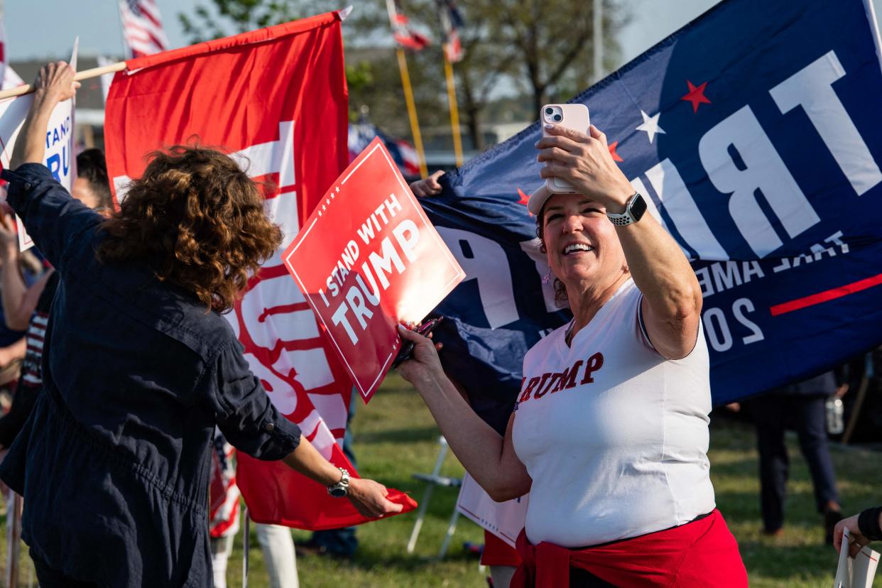 Supporters of former US President and 2024 Presidential hopeful Donald Trump rally to welcome him at Manchester airport in Manchester, New Hampshire, on May 10, 2023 ahead of his CNN town hall meeting.