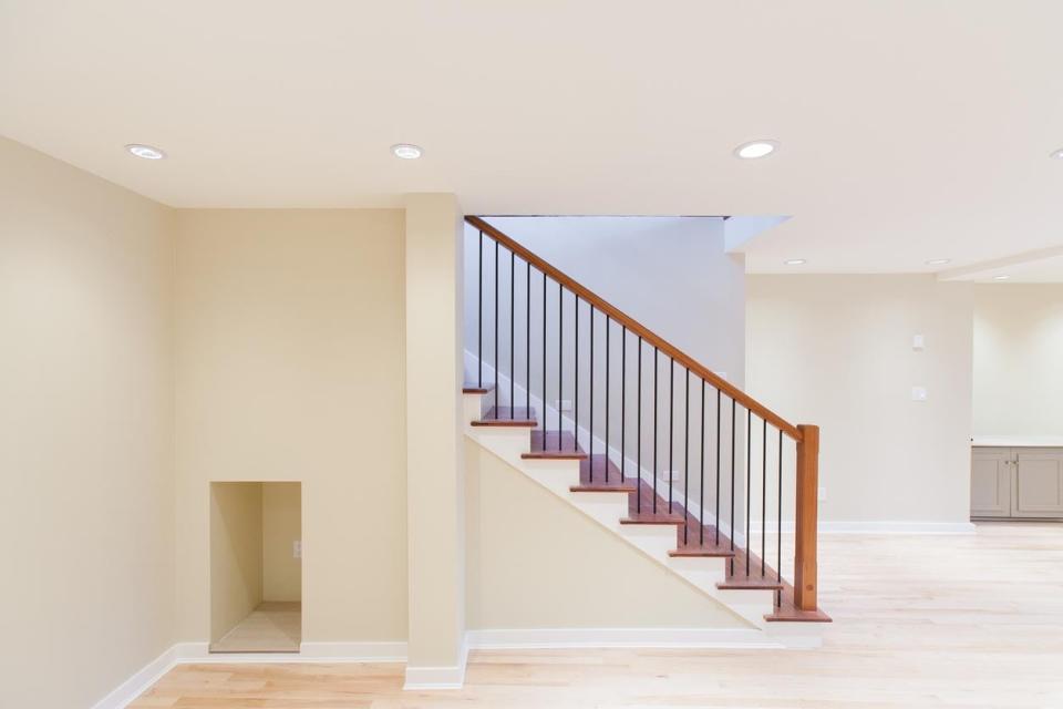 A finished basement is painted white.