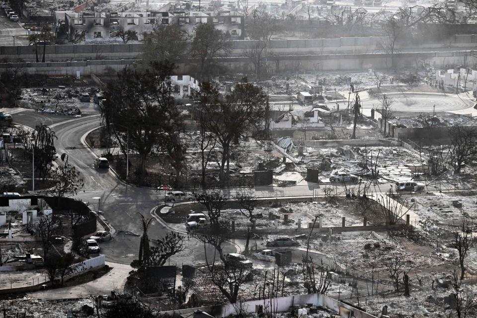 TOPSHOT - An aerial image taken on August 10, 2023 shows destroyed homes and buildings burned to the ground in Lahaina in the aftermath of wildfires in western Maui, Hawaii. At least 36 people have died after a fast-moving wildfire turned Lahaina to ashes, officials said August 9, 2023 as visitors asked to leave the island of Maui found themselves stranded at the airport. The fires began burning early August 8, scorching thousands of acres and putting homes, businesses and 35,000 lives at risk on Maui, the Hawaii Emergency Management Agency said in a statement. (Photo by Patrick T. Fallon / AFP) (Photo by PATRICK T. FALLON/AFP via Getty Images)