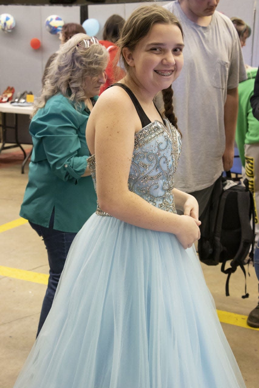 An Alliance High School student shows off a big smile March 17, 2023, during Project Prom, an event during which students can pick out dresses, shoes and accessories at no cost.