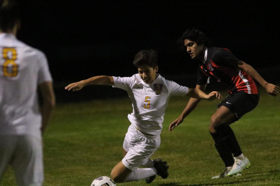 Clarksville's Mark Allen (5) is tripped up as he advances on the ball against Rossview in the first half during their District 13-4A game Wednesday, April 27, 2022 at Rossview High School.