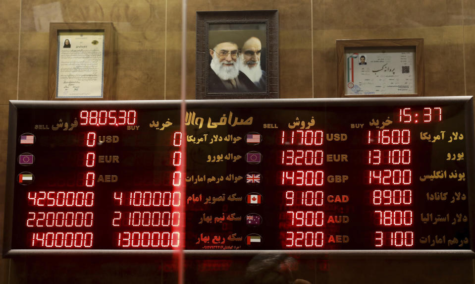 Various rates and prices for currencies and gold coins are displayed at an exchange bureau, in Tehran, Iran, Wednesday, Aug. 21, 2019. Iran's president sent a bill to parliament Wednesday that would cut four zeroes from the value of the Islamic Republic's sanctions-battered currency, the rial, as tensions remain high between Tehran and Washington. (AP Photo/Ebrahim Noroozi)