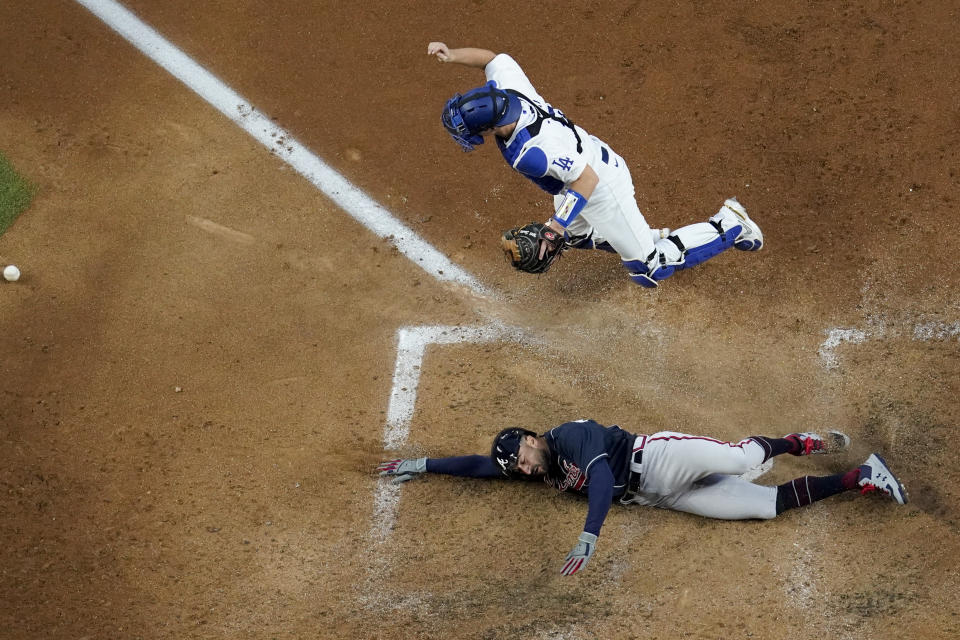Atlanta Braves' Nick Markakis scores past Los Angeles Dodgers catcher Will Smith on a double by Cristian Pache during the fifth inning in Game 2 of a baseball National League Championship Series Tuesday, Oct. 13, 2020, in Arlington, Texas. (AP Photo/David J. Phillip)