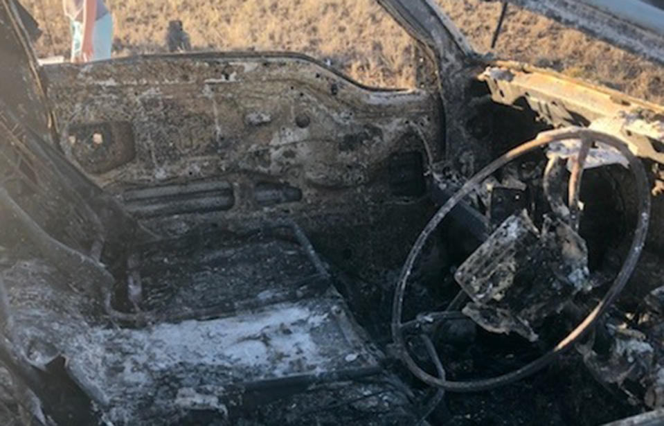 A burnt out wreck on the Nullarbor Plain is all that remains of the van the couple bought to travel around Australia. Source: Adam Papadopoulos