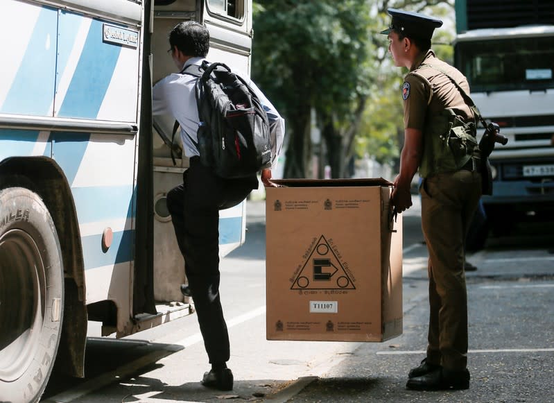 Sri Lankan police and election officials load ballot boxes and papers into busses from a distribution center to polling stations, ahead of country's presidential election scheduled on 16th November, in Colombo