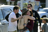 <p>a Trader Joes employee hugs her loved ones just outside the store where a man held employees hostage and killed one woman in Silverlake, Calif. on Saturday, July 21, 2018. (Photo: Christian Monterosa via AP) </p>