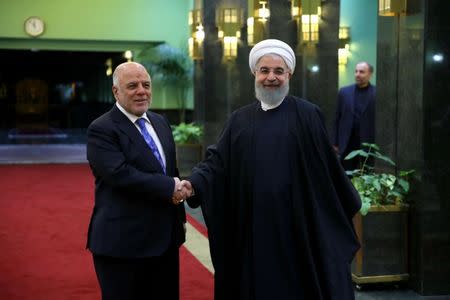 Iranian President Hassan Rouhani shakes hands with Iraqi Prime Minister Haider Al-Abadi, in Tehran, Iran, October 26, 2017. President.ir/Handout via REUTERS ATTENTION EDITORS - THIS PICTURE WAS PROVIDED BY A THIRD PARTY. NO RESALES. NO ARCHIVE.