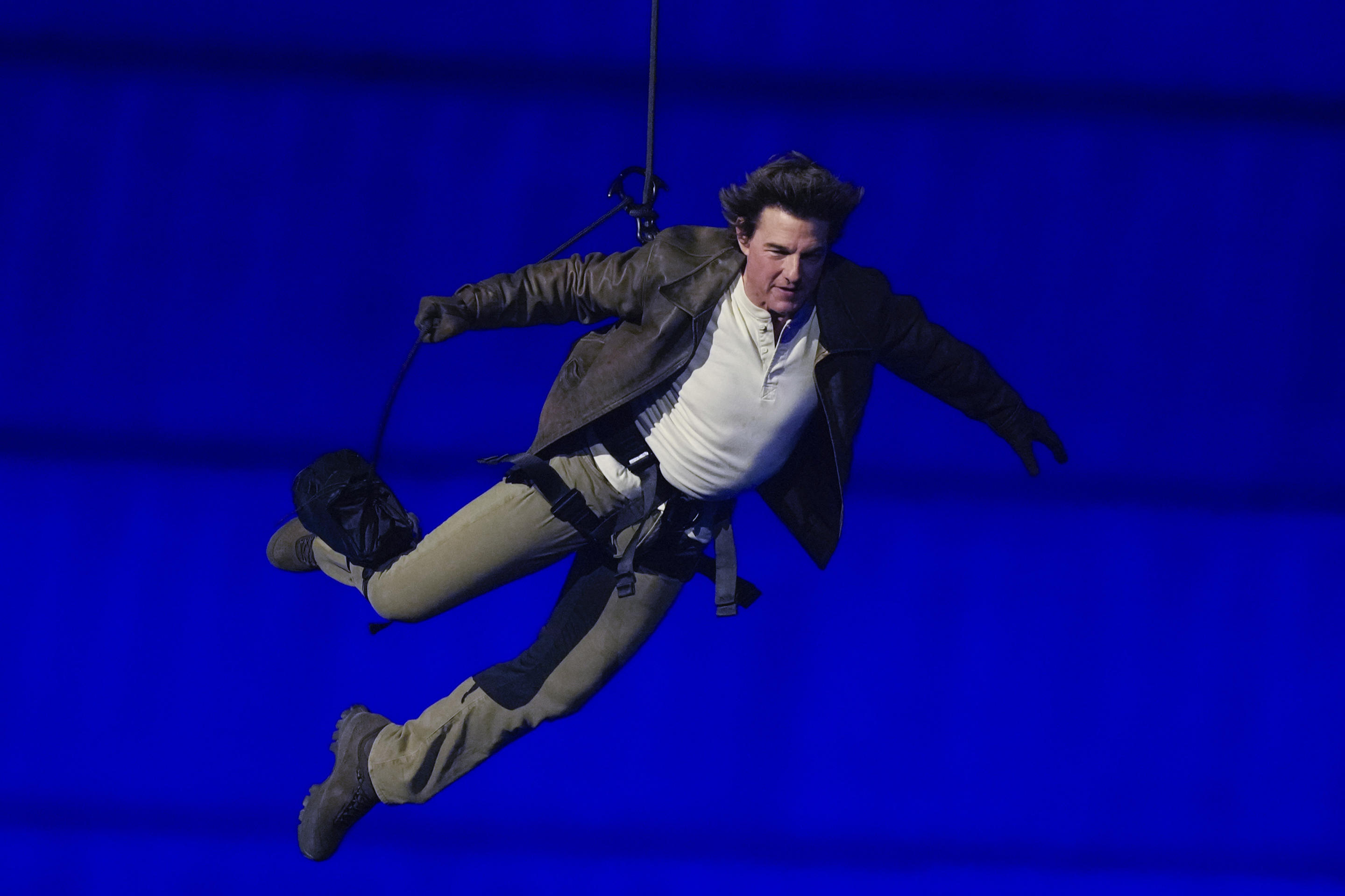 Actor Tom Cruise is lowered onto the Stade de France during the closing ceremony. 