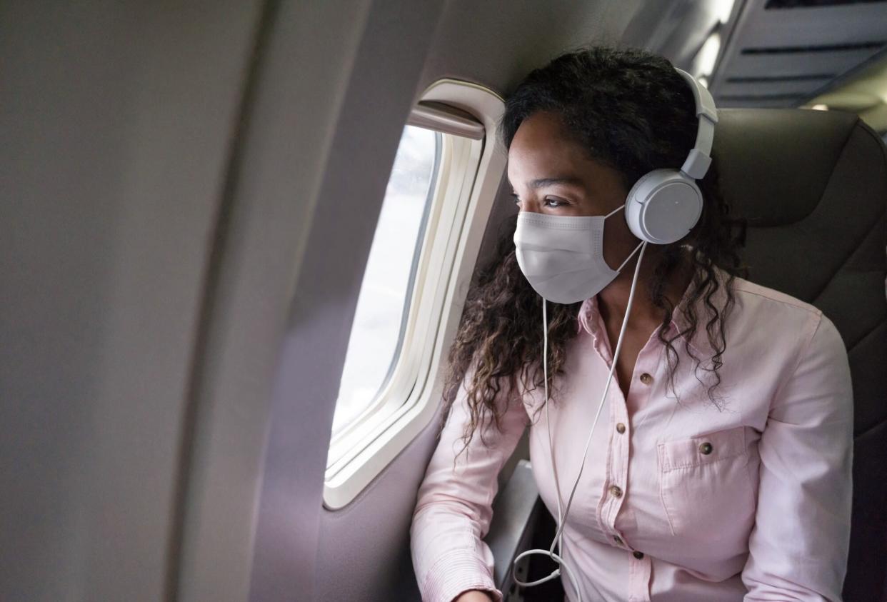 woman wearing face mask on ariplane