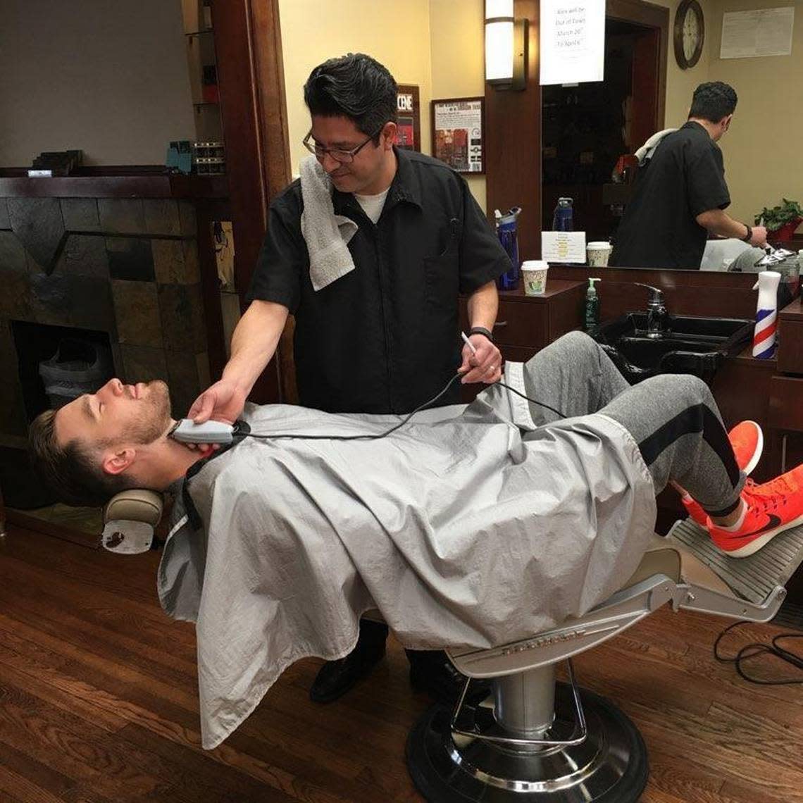 Travis Kelce in 2016 receiving a trim in Cleveland Heights, Ohio from hometown friend Alex Quintana at Quintana’s Barber & Dream Spa.