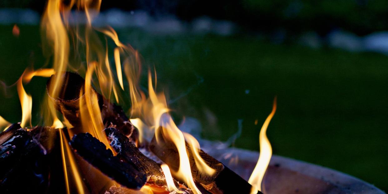 how to keep garden warm in winter, closeup of burning fire pit at night