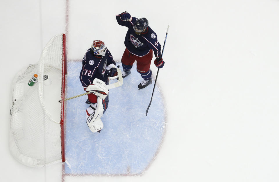 Columbus Blue Jackets' Sergei Bobrovsky, of Russia, and David Savard celebrate their win over the Tampa Bay Lightning in Game 4 of an NHL hockey first-round playoff series, Tuesday, April 16, 2019, in Columbus, Ohio. (AP Photo/Jay LaPrete)