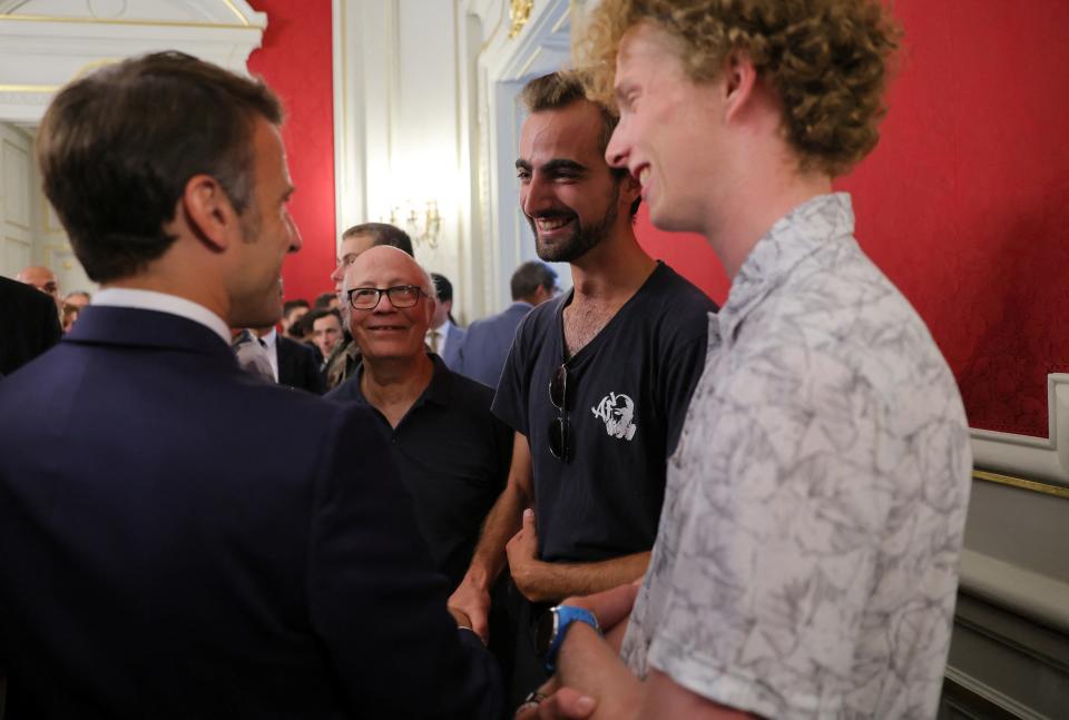 Emmanuel Macron meets Henri, the 24-year-old ‘backpack hero’, his friend Lilian and Youssouf, who suffered minor stab wounds as he tried to intercept the suspect (REUTERS/Denis Balibouse/Pool)