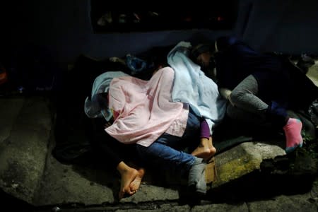 Central American migrants sleep outside the Mexican Commission for Refugee Aid (COMAR) in Tapachula