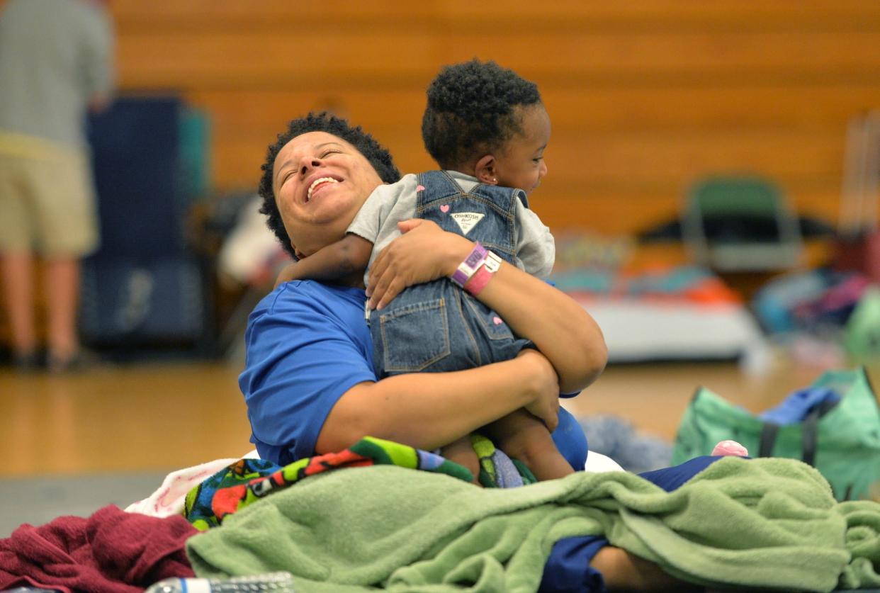 Stephanie Adams plays with her daughter, Alessia, on Oct. 3 at the hurricane shelter at Venice High School. After Hurricane Ian, Adams and her family were evacuated from their North Port home by airboat.