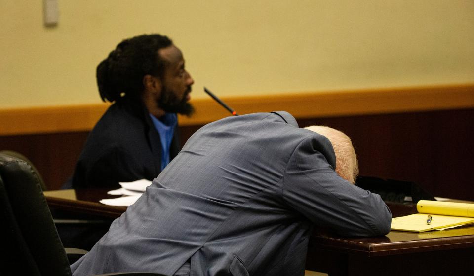 An exasperated Lee Hollander briefly puts his head on the desk during the penalty phase of the trial for Wisner Desmaret on Thursday. Desmaret was found guilty of eight charges including a capital murder offense in the 2018 killing of Fort Myers Police officer Adam Jobbers-Miller. Hollander is standby counsel for Desmaret, who is representing himself. Desmerat wants Hollander off his case because he believes he is not helping him.