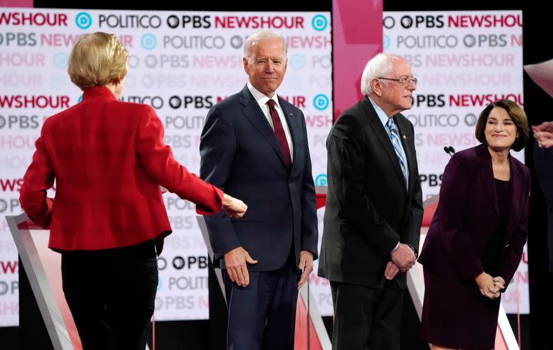 Democratic U.S. presidential candidate Warren joins Biden, Sanders and Klobuchar onstage before the start of the sixth Democratic presidential candidates campaign debate at Loyola Marymount University in Los Angeles