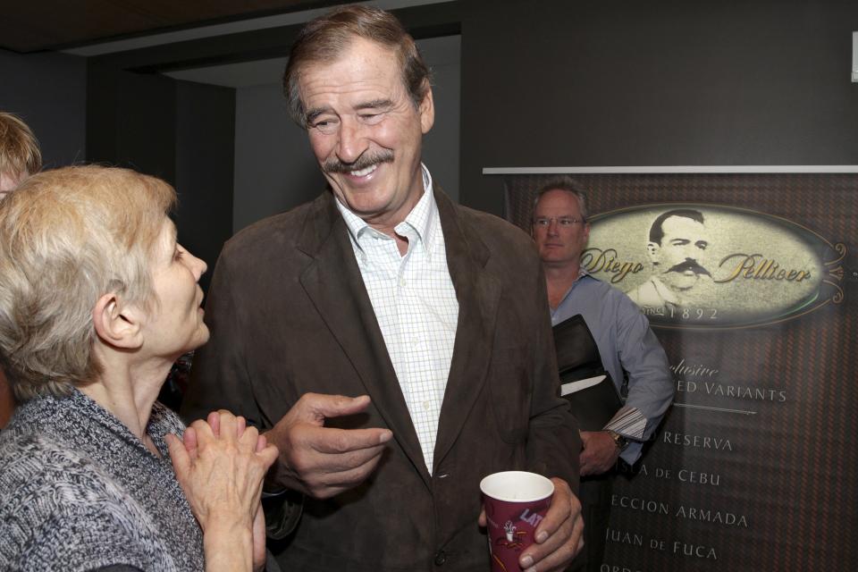 Former President of Mexico Vicente Fox (C) talks with Tana Lee Tolson (L) from Nurses Union for Cannabis Hospices before a news conference held by commercial marijuana company Diego Pellicer Inc. in Seattle, Washington, in this May 30, 2013 file photo. The legalization of marijuana is "irreversible" in drug-scarred Mexico following a key court ruling, former President Vicente Fox says, forecasting all drugs including cocaine and crystal meth will be freely available within a decade. Earlier this month, the Supreme Court gave the green light to growing marijuana for recreational use, a landmark decision that blasts open the door for an eventual legalization in Mexico, where warring gangs sparked a decade of drug violence. REUTERS/Marcus Donner/Files