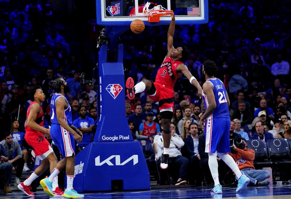 The Raptors' OG Anunoby dunks between the Sixers' James Harden, left, and Joel Embiid during Game 5 of the teams' playoff series.
