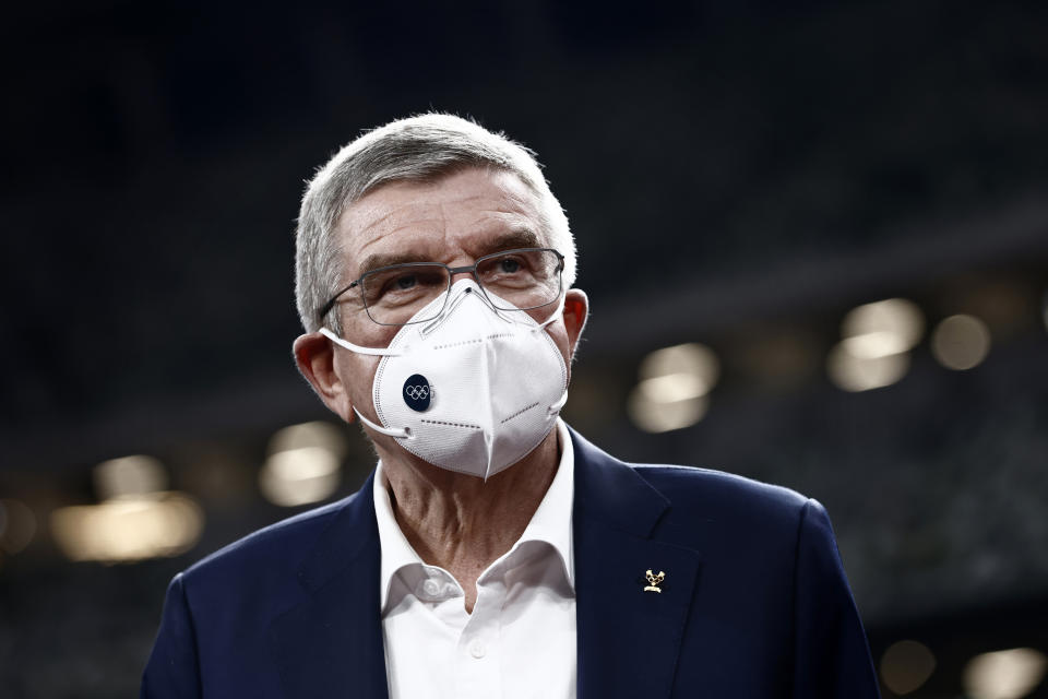 FILE - In this Nov. 17, 2020, file photo, IOC President Thomas Bach visits the National Stadium, the main venue for the 2020 Olympic and Paralympic Games postponed until July 2021 due to the coronavirus pandemic, in Tokyo. Bach has canceled a trip in May 2021 to Japan because of surging cases of COVID-19 in the country, the Tokyo Olympic organizing committee said Monday, May 10, 2021 in a statement. The trip was made impossible because of a state of emergency in Tokyo and other parts of the country that has been extended until May 31. (Behrouz Mehri/Pool Photo via AP, Fo;e)