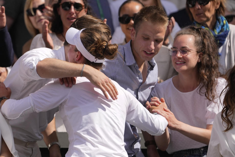 Barbora Krejcikova of the Czech Republic celebrates with her team in the players box after defeating Jasmine Paolini of Italy in the women's singles final at the Wimbledon tennis championships in London, Saturday, July 13, 2024. (AP Photo/Alberto Pezzali)