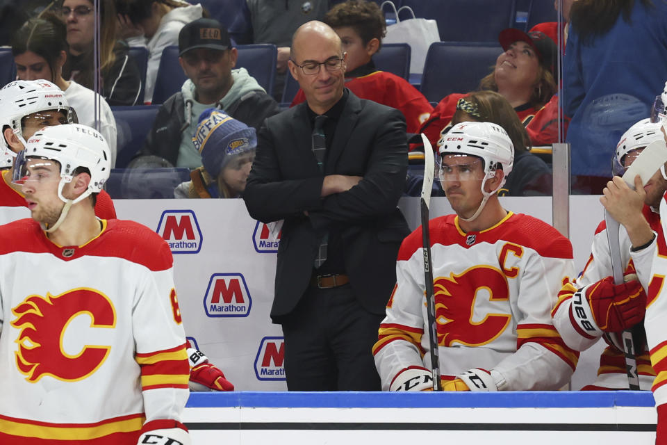 Calgary Flames head coach Ryan Huska, center, reacts during the second period of an NHL hockey game against the Buffalo Sabres, Thursday, Oct. 19, 2023, in Buffalo, N.Y. (AP Photo/Jeffrey T. Barnes)