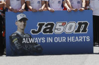 Teammates of 19 years-old Swiss pilot Jason Dupasquier pay a minute of silence in his memory prior to the start of the Motogp Grand Prix of Italy at the Mugello circuit, in Scarperia, Italy, Sunday, May 30, 2021. Dupasquier died Sunday after being hospitalized Saturday, at the Florence hospital following his crash during the qualifying practices of the Moto3. (AP Photo/Antonio Calanni)