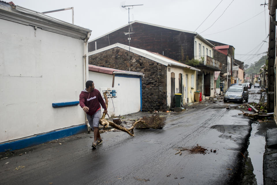 <p>A man clears debris from a street in Saint-Pierre, on the French Caribbean island of Martinique, after it was hit by Hurricane Maria, on Sept. 19, 2017. (Photo: Lionel Chamoiseau/AFP/Getty Images) </p>