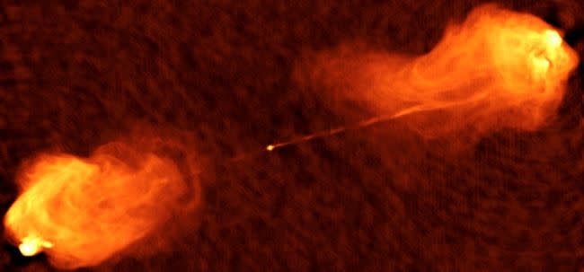 radio telescope image of orange flame-like objects erupting from a bright point of light in deep space