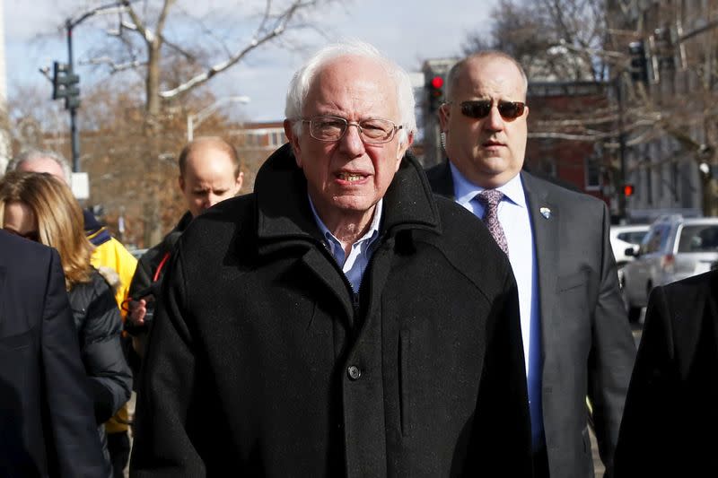 Democratic U.S. presidential candidate Bernie Sanders walks along a street near a polling place in Concord, New Hampshire February 9, 2016. REUTERS/Shannon Stapleton