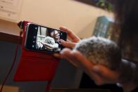 A woman takes a selfie with a hedgehog at the Harry hedgehog cafe in Tokyo, Japan, April 5, 2016. In a new animal-themed cafe, 20 to 30 hedgehogs of different breeds scrabble and snooze in glass tanks in Tokyo's Roppongi entertainment district. Customers have been queuing to play with the prickly mammals, which have long been sold in Japan as pets. The cafe's name Harry alludes to the Japanese word for hedgehog, harinezumi. REUTERS/Thomas Peter