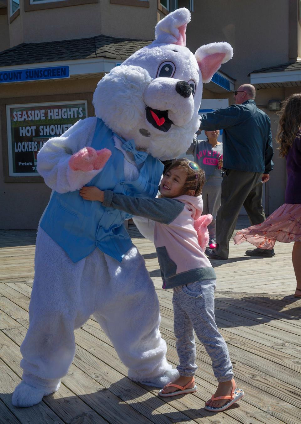 Ava Weber,3, of Island Heights hugs the Easter bunny during a visit to the boardwalk. Easter on the boardwalk in Seaside Heights Easter Parade where Mayor Anthony Vaz and council members will gave out spring flowers to the people who came out to enjoy the day. There was a judging later in the day for best Easter outfits. 