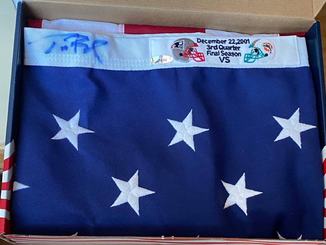 This provided photo shows Vitale’s flag autographed by Tom Brady before the signature faded. Michael Lambert