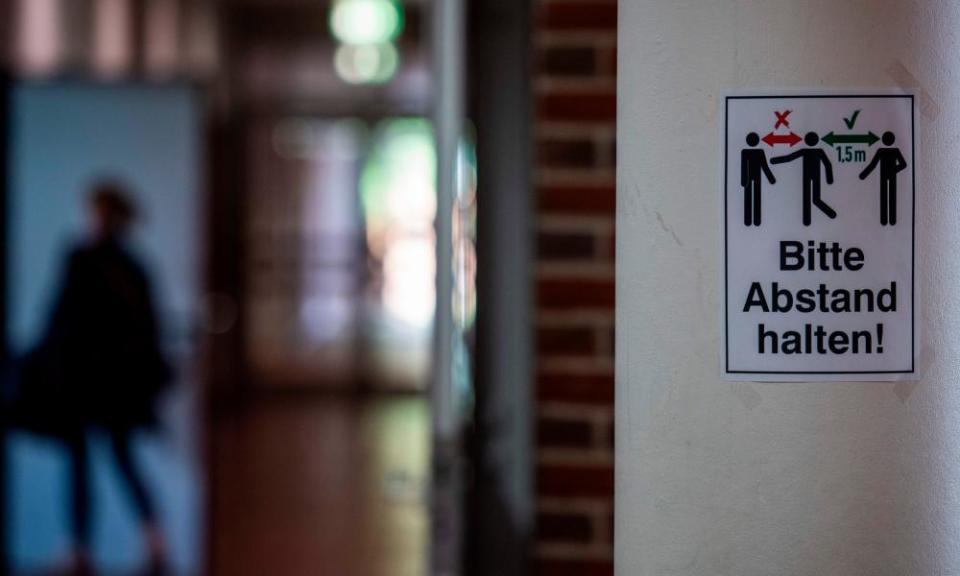 A sign reading ‘keep your distance’ in a corridor at Christophorus school in Rostock, northern Germany