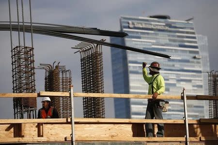 Men work on a construction site for a luxury apartment complex in downtown Los Angeles, California March 17, 2015. REUTERS/Lucy Nicholson