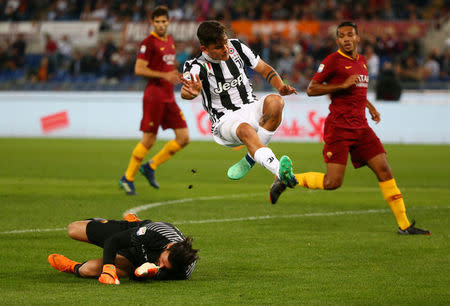 Soccer Football - Serie A - AS Roma vs Juventus - Stadio Olimpico, Rome, Italy - May 13, 2018 Juventus' Paulo Dybala in action with Roma's Alisson Becker REUTERS/Alessandro Bianchi