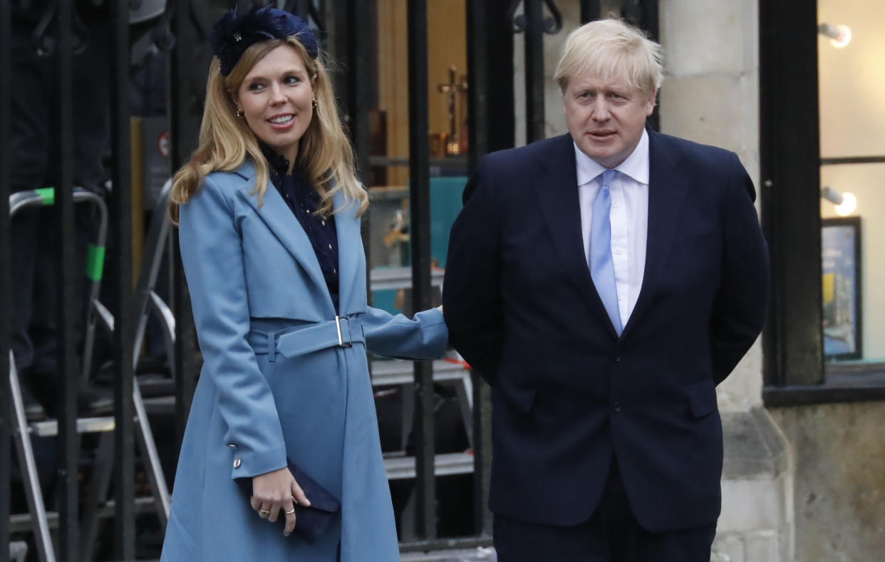 Britain's Prime Minister Boris Johnson (R) with his partner Carrie Symonds leave after attending the annual Commonwealth Service at Westminster Abbey in London on March 09, 2020. - Britain's Queen Elizabeth II has been the Head of the Commonwealth throughout her reign. Organised by the Royal Commonwealth Society, the Service is the largest annual inter-faith gathering in the United Kingdom. (Photo by Tolga AKMEN / AFP) (Photo by TOLGA AKMEN/AFP via Getty Images)